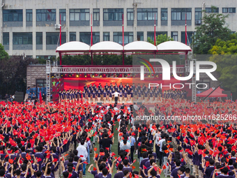 In Suqian, China, on September 30, 2024, 7,000 teachers and students gather at the campus sports field to hold a themed event called ''Repor...