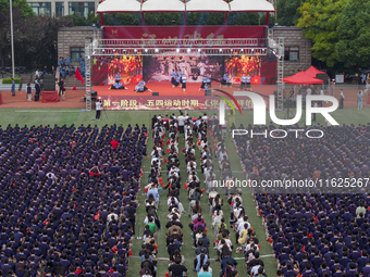 In Suqian, China, on September 30, 2024, 7,000 teachers and students gather at the campus sports field to hold a themed event called ''Repor...