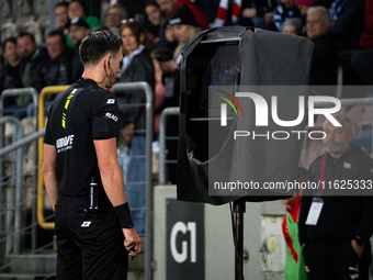 Referee Patryk Gryckiewicz checks the VAR screen during a game between KS Cracovia and Stal Mielec in Krakow, Poland, on September 30, 2024....