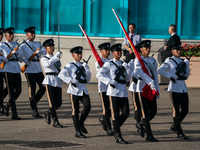 Police officers hold the China National Flag and the HKSAR Flag and march during the flag-raising ceremony in Hong Kong, China, on October 1...