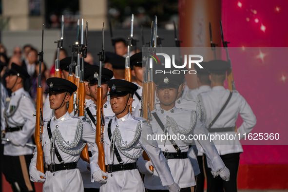 Police hold rifles while marching during the flag-raising ceremony in Hong Kong, China, on October 1, 2024. 