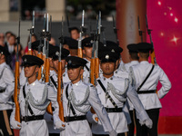 Police hold rifles while marching during the flag-raising ceremony in Hong Kong, China, on October 1, 2024. (