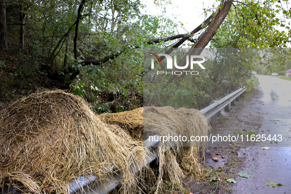 Hay bails lay atop a roadway guardrail in Chilhowie, Virginia on September 30, 2024, after Hurricane Helene caused severe flooding in the re...