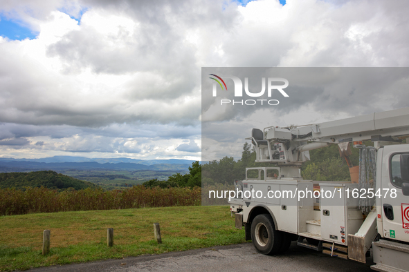 A utility vehicle is seen parked at an overlook in the Appalachian mountains near Whitetop, Virginia on September 30, 2024 as crews work to...