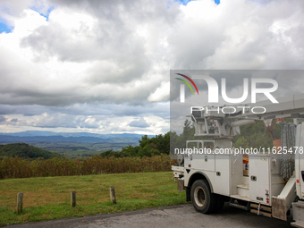 A utility vehicle is seen parked at an overlook in the Appalachian mountains near Whitetop, Virginia on September 30, 2024 as crews work to...