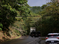 A truck is entangled in wires after passing through a damaged roadway in Whitetop, Virginia on September 30, 2024. (