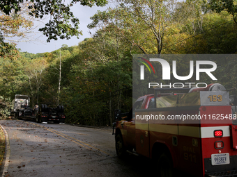 A truck is entangled in wires after passing through a damaged roadway in Whitetop, Virginia on September 30, 2024. (