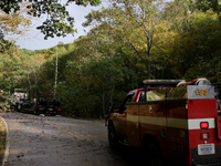 A truck is entangled in wires after passing through a damaged roadway in Whitetop, Virginia on September 30, 2024. (