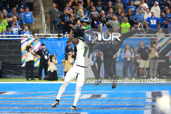 DETROIT,MICHIGAN-September 30: Detroit Lions safety Kerby Joseph (31) intercepts a pass intended for Seattle Seahawks wide receiver Jaxon Sm...