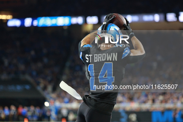 DETROIT,MICHIGAN-September 30: Detroit Lions wide receiver Amon-Ra St. Brown (14) catches a pass for a touchdown during the second half of a...