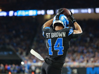 DETROIT,MICHIGAN-September 30: Detroit Lions wide receiver Amon-Ra St. Brown (14) catches a pass for a touchdown during the second half of a...