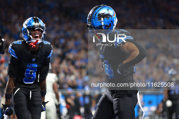 DETROIT,MICHIGAN-September 30: Detroit Lions wide receiver Amon-Ra St. Brown (14) celebrates his touchdown with teammate wide receiver James...