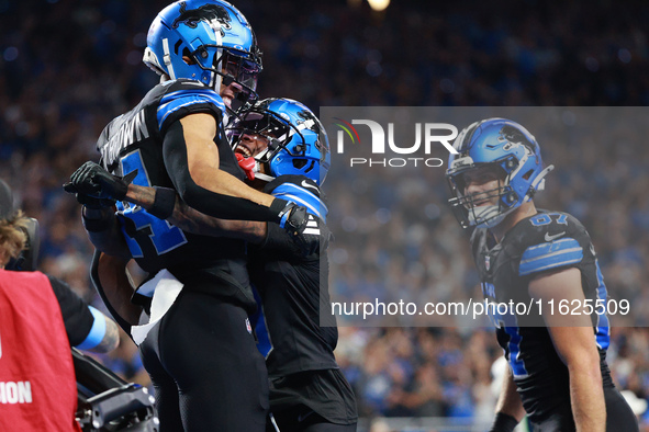 DETROIT,MICHIGAN-September 30: Detroit Lions wide receiver Amon-Ra St. Brown (14) celebrates his touchdown with teammate wide receiver James...