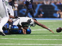 DETROIT,MICHIGAN-September 30: Seattle Seahawks quarterback Geno Smith (7) gets sucked by Detroit Lions defensive end Levi Onwuzurike (91) d...