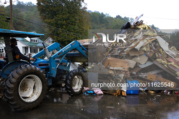 A bulldozer piles collected debris in Lansing, North Carolina on September 30, 2024 after Hurricane Helene caused widespread damage to the r...