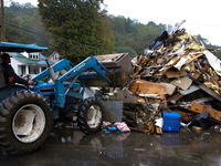 A bulldozer piles collected debris in Lansing, North Carolina on September 30, 2024 after Hurricane Helene caused widespread damage to the r...