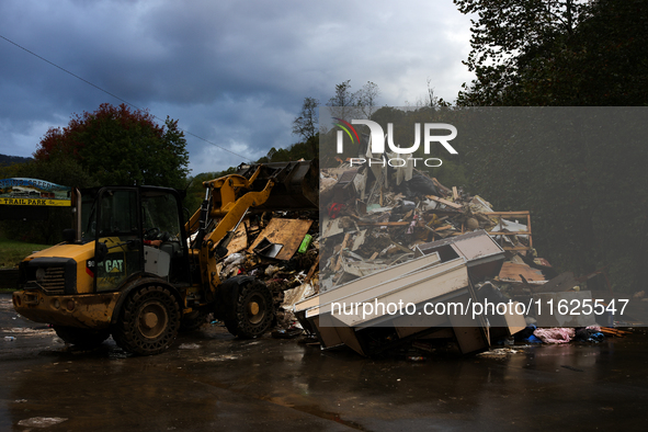 A bulldozer piles collected debris in Lansing, North Carolina on September 30, 2024 after Hurricane Helene caused widespread damage to the r...