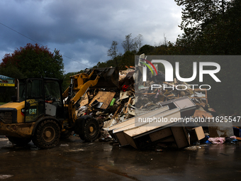 A bulldozer piles collected debris in Lansing, North Carolina on September 30, 2024 after Hurricane Helene caused widespread damage to the r...