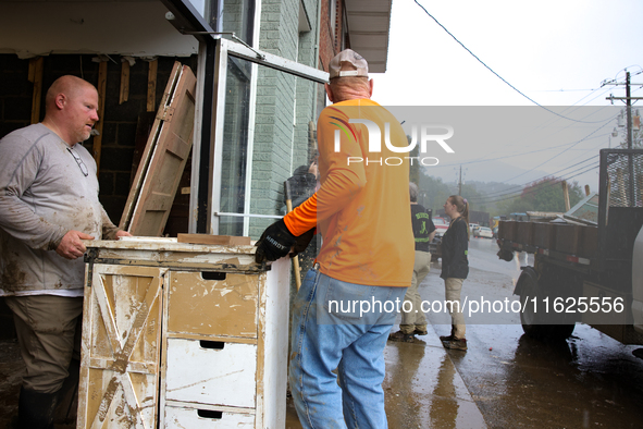 People remove furniture from a business in Lansing, North Carolina on September 30, 2024 after Hurricane Helene caused widespread damage in...