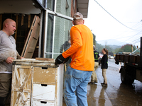 People remove furniture from a business in Lansing, North Carolina on September 30, 2024 after Hurricane Helene caused widespread damage in...