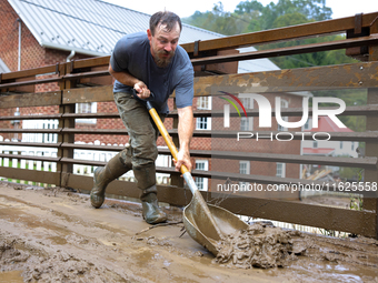 Austin, a resident of Lansing, North Carolina, clears debris from a bridge on September 30, 2024 after Hurricane Helene caused widespread fl...