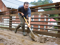 Austin, a resident of Lansing, North Carolina, clears debris from a bridge on September 30, 2024 after Hurricane Helene caused widespread fl...