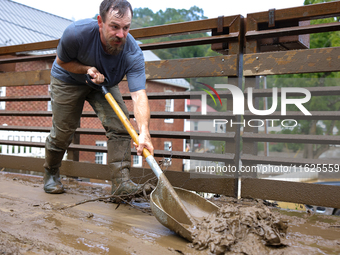 Austin, a resident of Lansing, North Carolina, clears debris from a bridge on September 30, 2024 after Hurricane Helene caused widespread fl...