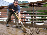 Austin, a resident of Lansing, North Carolina, clears debris from a bridge on September 30, 2024 after Hurricane Helene caused widespread fl...