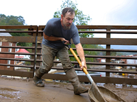 Austin, a resident of Lansing, North Carolina, clears debris from a bridge on September 30, 2024 after Hurricane Helene caused widespread fl...