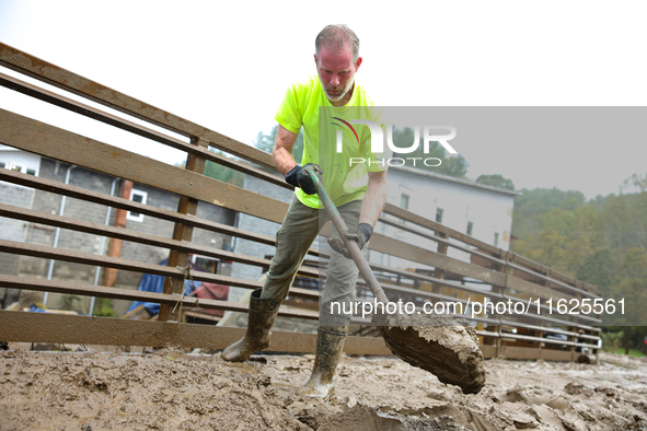 Mike, a resident of Lansing, North Carolina, clears debris from a bridge on September 30, 2024 after Hurricane Helene caused widespread floo...