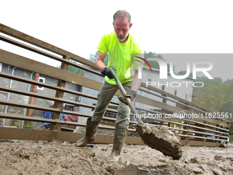 Mike, a resident of Lansing, North Carolina, clears debris from a bridge on September 30, 2024 after Hurricane Helene caused widespread floo...