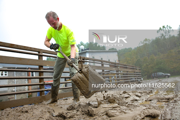 Mike, a resident of Lansing, North Carolina, clears debris from a bridge on September 30, 2024 after Hurricane Helene caused widespread floo...