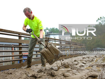 Mike, a resident of Lansing, North Carolina, clears debris from a bridge on September 30, 2024 after Hurricane Helene caused widespread floo...