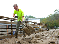 Mike, a resident of Lansing, North Carolina, clears debris from a bridge on September 30, 2024 after Hurricane Helene caused widespread floo...