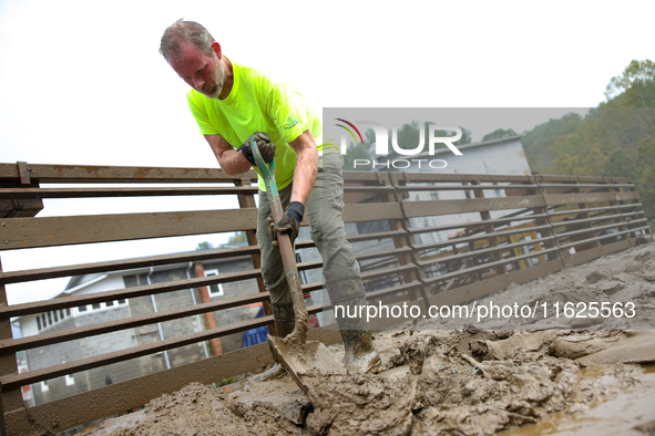 Mike, a resident of Lansing, North Carolina, clears debris from a bridge on September 30, 2024 after Hurricane Helene caused widespread floo...