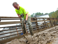 Mike, a resident of Lansing, North Carolina, clears debris from a bridge on September 30, 2024 after Hurricane Helene caused widespread floo...