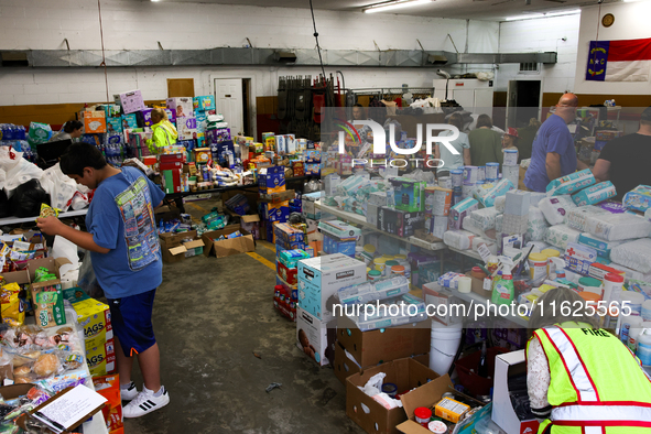 People collect donations at the Lansing Volunteer Fire Department in Lansing, North Carolina on September 30, 2024, after Hurricane Helene c...