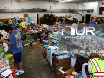 People collect donations at the Lansing Volunteer Fire Department in Lansing, North Carolina on September 30, 2024, after Hurricane Helene c...