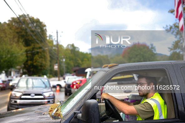 A volunteer delivers donations at the Lansing Volunteer Fire Department in Lansing, North Carolina on September 30, 2024, after Hurricane He...