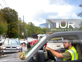 A volunteer delivers donations at the Lansing Volunteer Fire Department in Lansing, North Carolina on September 30, 2024, after Hurricane He...