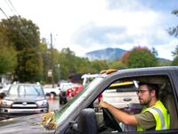 A volunteer delivers donations at the Lansing Volunteer Fire Department in Lansing, North Carolina on September 30, 2024, after Hurricane He...