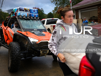 Volunteers deliver donations at the Lansing Volunteer Fire Department in Lansing, North Carolina on September 30, 2024, after Hurricane Hele...