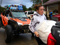 Volunteers deliver donations at the Lansing Volunteer Fire Department in Lansing, North Carolina on September 30, 2024, after Hurricane Hele...