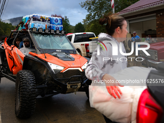 Volunteers deliver donations at the Lansing Volunteer Fire Department in Lansing, North Carolina on September 30, 2024, after Hurricane Hele...