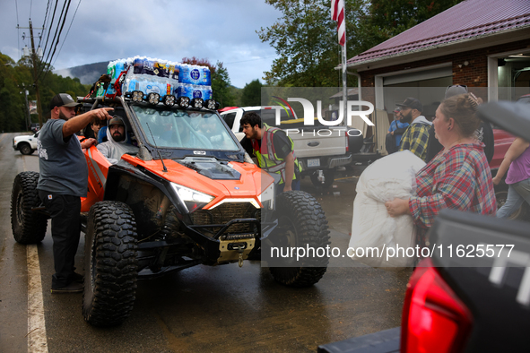 Volunteers deliver donations at the Lansing Volunteer Fire Department in Lansing, North Carolina on September 30, 2024, after Hurricane Hele...