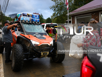 Volunteers deliver donations at the Lansing Volunteer Fire Department in Lansing, North Carolina on September 30, 2024, after Hurricane Hele...