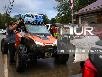 Volunteers deliver donations at the Lansing Volunteer Fire Department in Lansing, North Carolina on September 30, 2024, after Hurricane Hele...