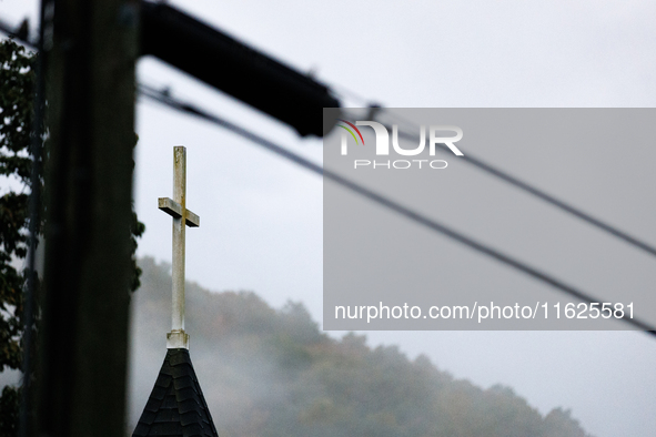 A church steeple rises in front of evening fog in Lansing, North Carolina on September 30, 2024 after Hurricane Helene caused widespread dam...