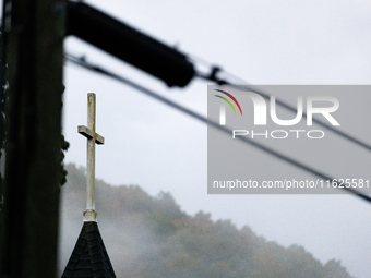 A church steeple rises in front of evening fog in Lansing, North Carolina on September 30, 2024 after Hurricane Helene caused widespread dam...