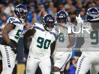 DETROIT,MICHIGAN-September 30: Seattle Seahawks defensive tackle Jarran Reed (90) celebrates with teammates after a play during the first ha...